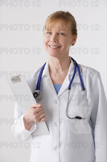 Portrait of female doctor, studio shot. Photo : Rob Lewine