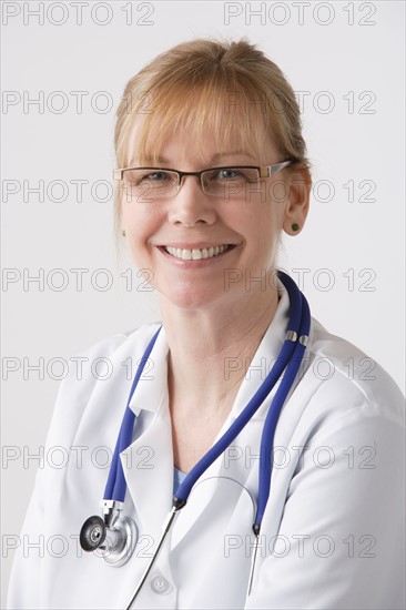 Portrait of female doctor, studio shot. Photo : Rob Lewine