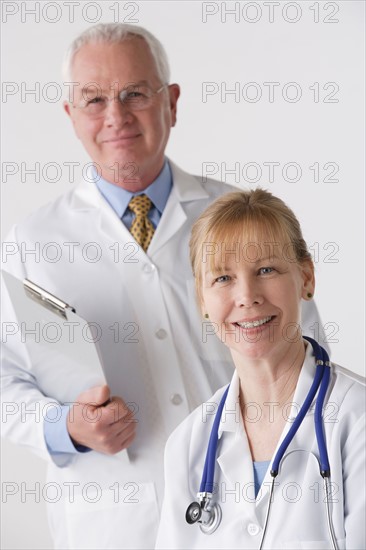 Portrait of female and male doctor, studio shot. Photo: Rob Lewine
