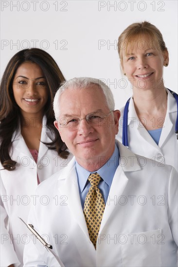 Portrait of three medical professionals, studio shot. Photo : Rob Lewine