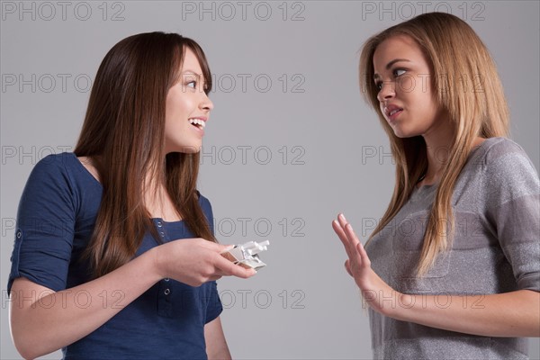 Teenage girl (16-17) rejecting cigarette. Photo : Rob Lewine