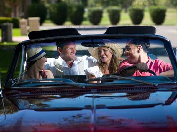 Friends driving convertible car. Photo : db2stock