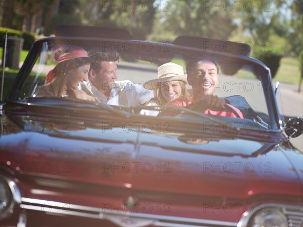 Friends driving convertible car. Photo : db2stock