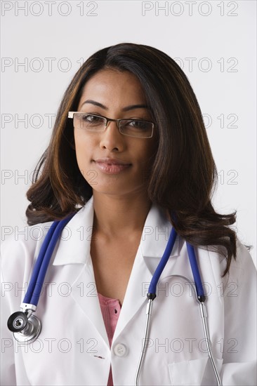 Portrait of young female doctor, studio shot. Photo: Rob Lewine