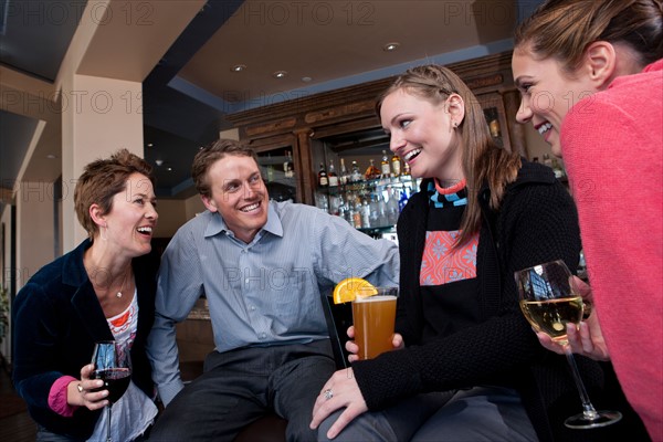 Group of people enjoying apres ski drink in bar. Photo : db2stock