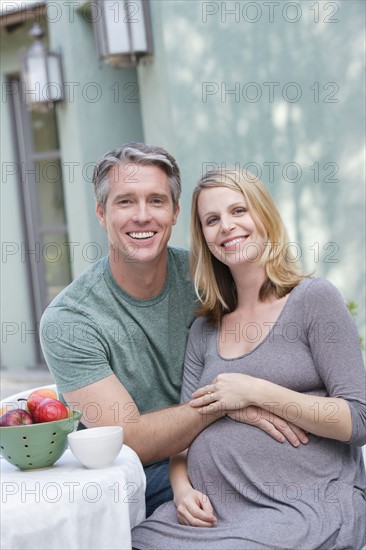 Portrait of pregnant woman with husband. Photo : Rob Lewine