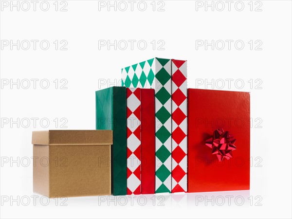 Four boxes with ribbon, studio shot. Photo: David Arky