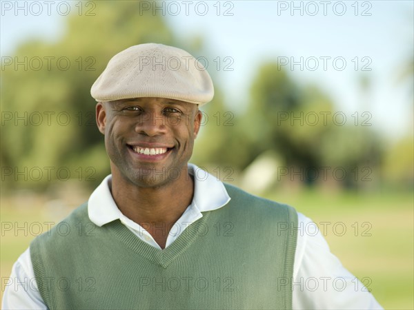 Smiling man on golf course. Photo: db2stock