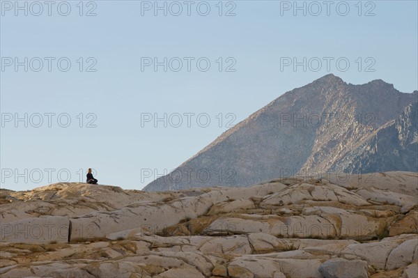 USA, California, Sequoia National Park, Mid adult woman meditating. Photo : Noah Clayton