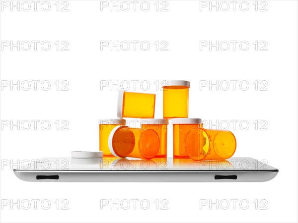 Studio shot of pill bottles on digital tablet. Photo : David Arky