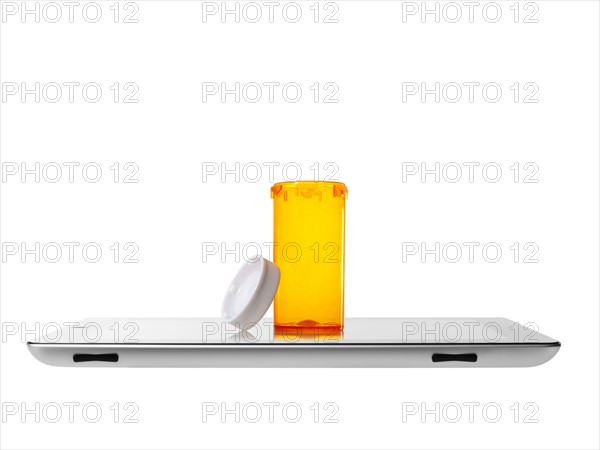 Studio shot of pill bottle on digital tablet. Photo: David Arky