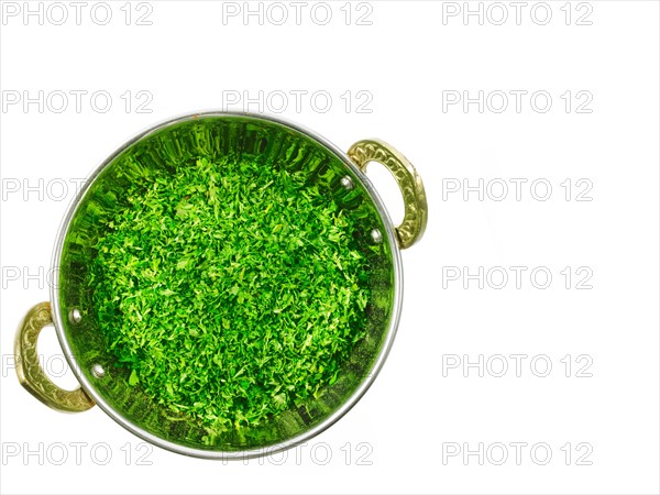 Studio shot of Parsley Flakes in pan on white background. Photo : David Arky