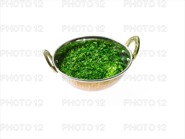 Studio shot of Parsley Flakes in pan on white background. Photo : David Arky