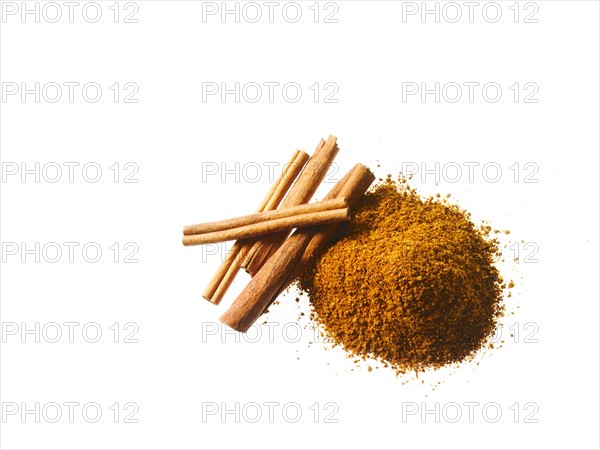 Studio shot of Ground Cinnamon and Cinnamon Sticks on white background. Photo: David Arky