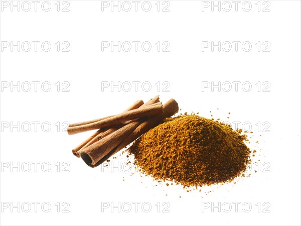 Studio shot of Ground Cinnamon and Cinnamon Sticks on white background. Photo: David Arky