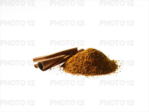 Studio shot of Ground Cinnamon and Cinnamon Sticks on white background. Photo : David Arky