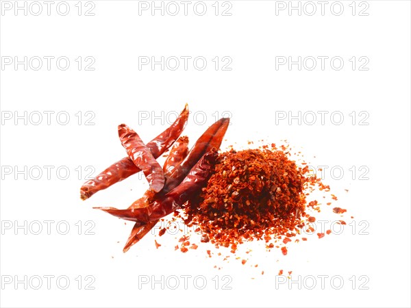 Studio shot of Red Chili Powder and Whole Red Chilies on white background. Photo : David Arky