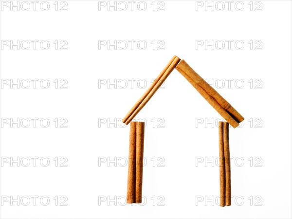 Studio shot of Cinnamon Sticks making House shape on white background. Photo: David Arky