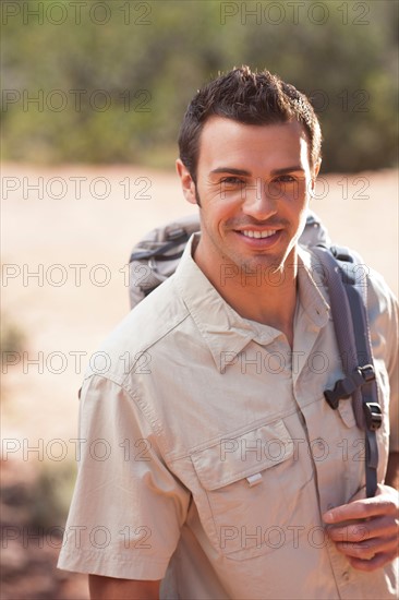 Young man hiking in desert. Photo : db2stock