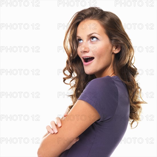 Studio portrait of beautiful woman looking surprised. Photo: momentimages