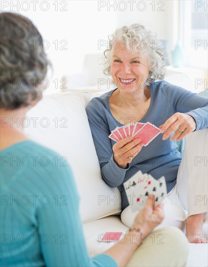 Two senior women playing cards. Photo: Daniel Grill