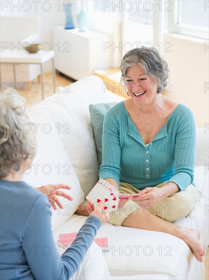 Two senior women playing cards. Photo : Daniel Grill