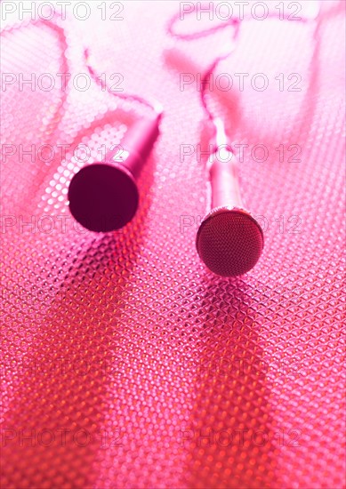 Close up of microphones lying on stage. Photo : Daniel Grill