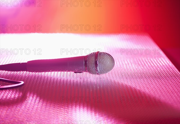 Close up of microphone lying on stage. Photo : Daniel Grill