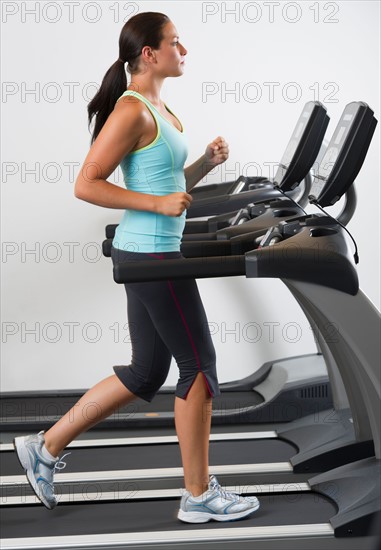 Woman walking on treadmill.