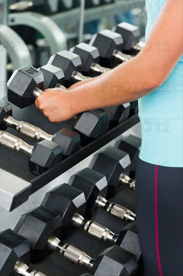 Woman lifting dumbbells.