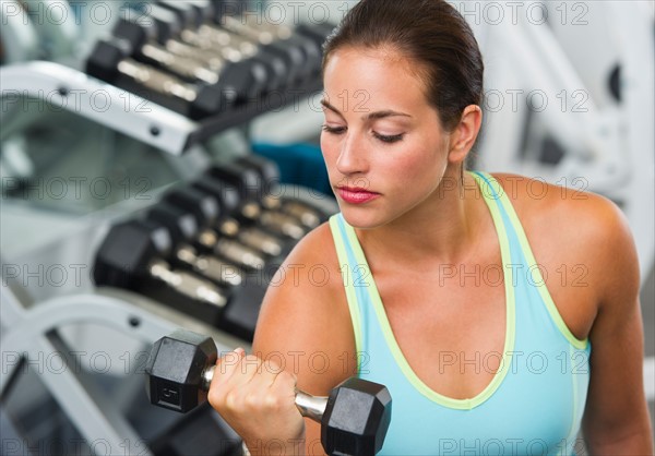 Woman exercising with dumbbells.