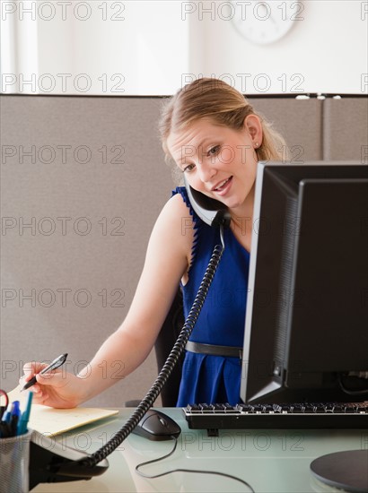 Young woman working in office. Photo : Jamie Grill