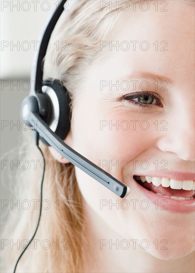 Young woman wearing headset. Photo : Jamie Grill