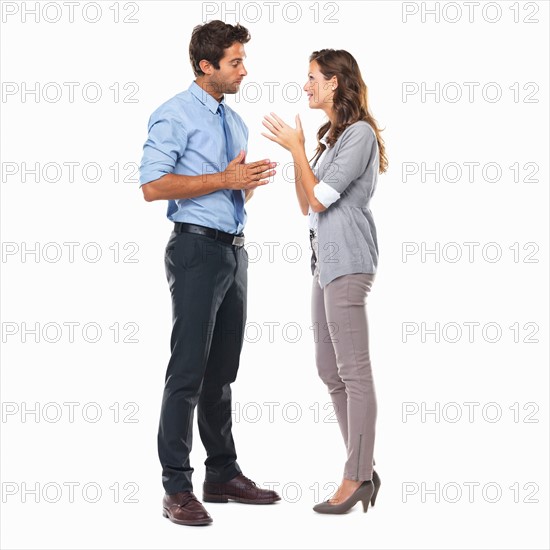 Business couple standing and having discussion. Photo : momentimages