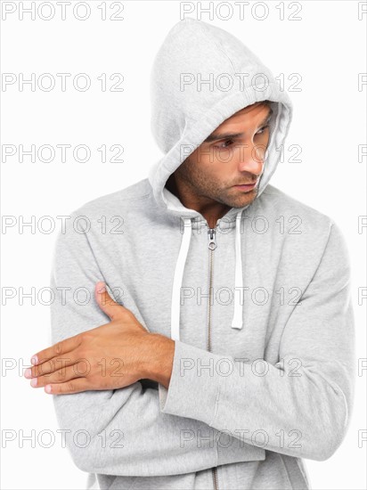 Young man in hoodie looking away. Photo : momentimages