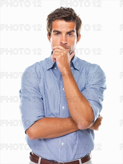 Portrait of business man standing and wondering. Photo : momentimages