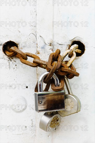 Padlocks and chains on gate.