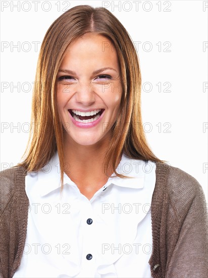 Studio portrait of beautiful business woman laughing. Photo : momentimages