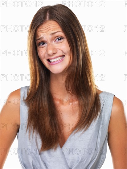 Studio portrait of woman with fake smile. Photo : momentimages