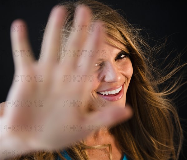 Portrait of woman covering camera. Photo: Jamie Grill