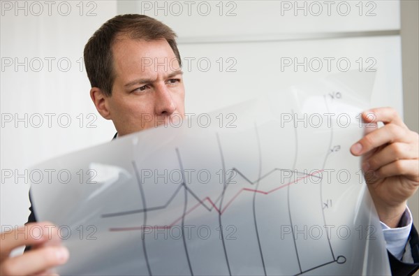 Businessman analyzing graphs.