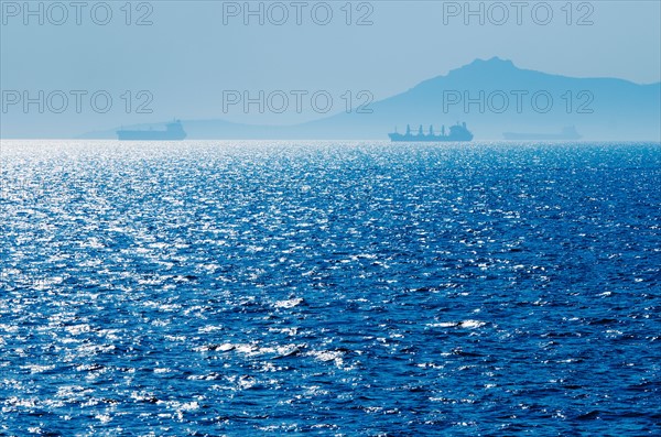 Greece, Oil tankers and cargo ships on Aegean Sea.