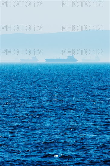 Greece, Oil tankers and cargo ships on Aegean Sea.
