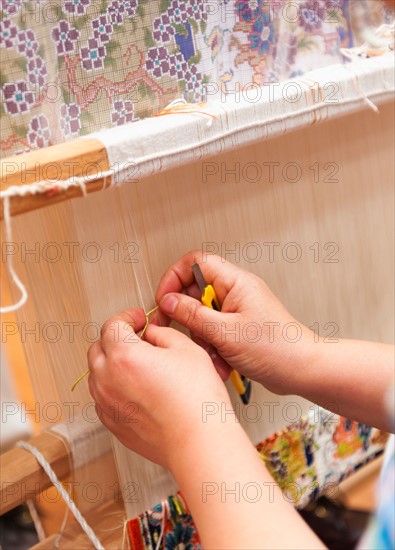 Turkey, Ephesus, Woman's hands weaving Turkish rug.