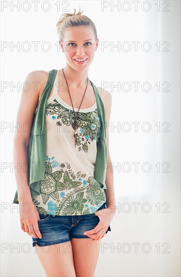 Studio portrait of woman smiling.