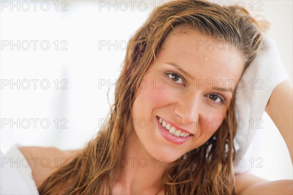 Portrait of woman drying hair.