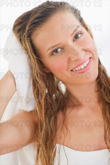 Portrait of woman drying hair.