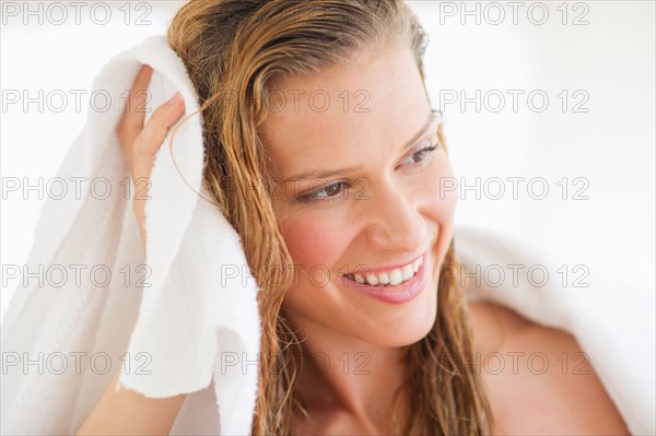 Portrait of woman drying hair.