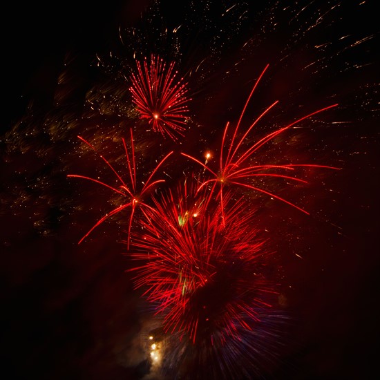 Fireworks explosion against night sky.