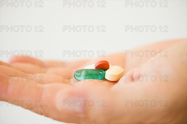 Hand holding pills.